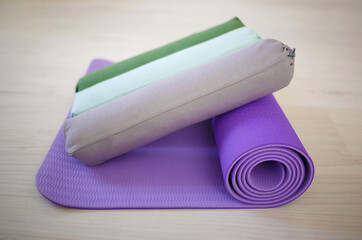 set for sports: pink massage roller on sports mat