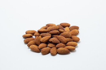 Almonds on a white background. Isolated almonds. Heap of roasted almonds