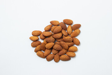 Almonds on a white background. Isolated almonds. Heap of roasted almonds