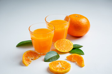 Fresh orange juice in the glass on marble background