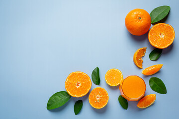 Fresh orange juice in the glass on blue background