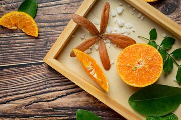 Fresh orange juice in the glass on dark wooden background