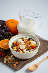  Cereal in bowl and mixed fruit on marble background