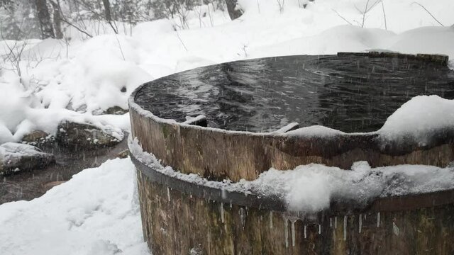 Geothermal spa. Woman relaxing in hot spring pool outdoors.