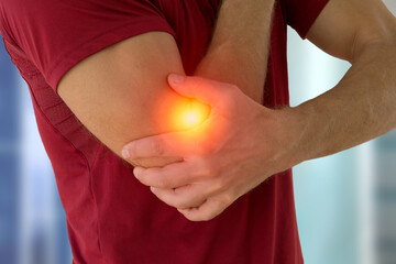 Health problem concept man suffering from elbow pain.