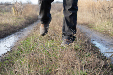 A tourist walks along a dirt road