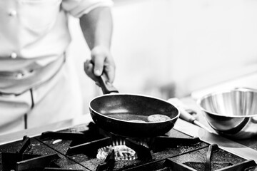 Chef cooking in a kitchen, chef at work, Black and White.