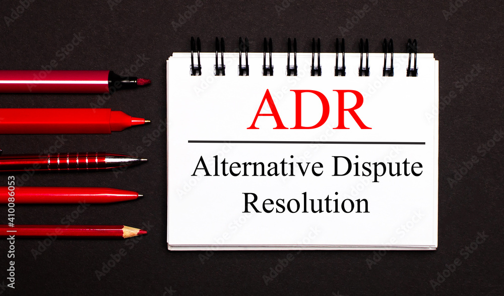 Poster a white notepad with the text adr alternative dispute resolution, written on a white notepad next to