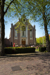 Fototapeta na wymiar Mennonites Church (Doopsgezinde Kerk) in Terherne, Netherlands, have Easter decorations in its front yard 