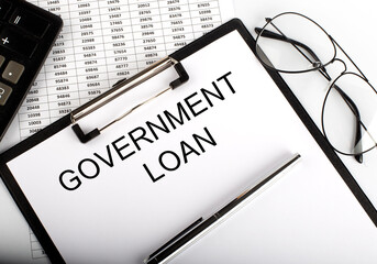 Paper with text GOVERNMENT LOAN on table