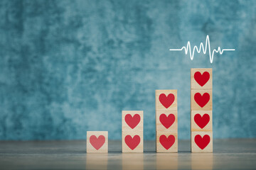 heart on wooden cubes arranged as graph for health concept