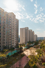Modern urban living quarters, residential buildings and garden under the sunlight