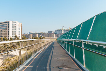 Diminishing Perspective View Of Empty Overpass with metal fence and  green acoustic panels in Xiamen City