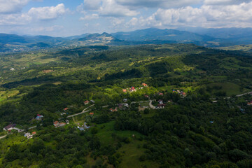 Aerial view of a linear settlement (village), in a hilly landscape, near Campulung Muscel, Romania