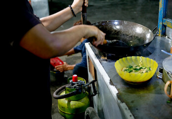 Indonesian hawker street food cooking noodle frying at night
