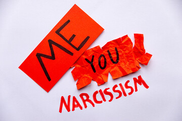 Pathological narcissism, narcissism and Gaslighting. Red paper with Me written on it, crumpled and...