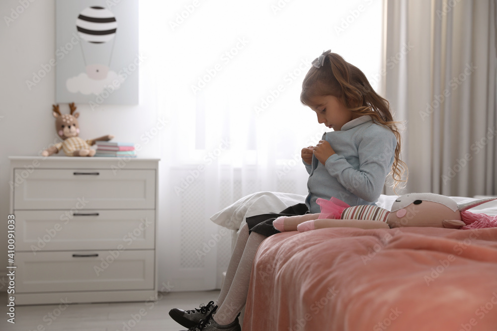 Wall mural Little girl getting ready for school in bedroom