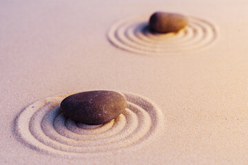 Fototapeta na wymiar Zen garden stones on sand with ornament