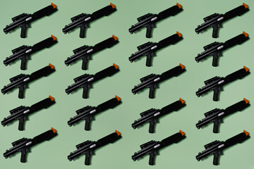 Pattern created of black rifle toys. A top view with pastel green background.