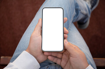 man in jeans holding gold phone with isolated screen