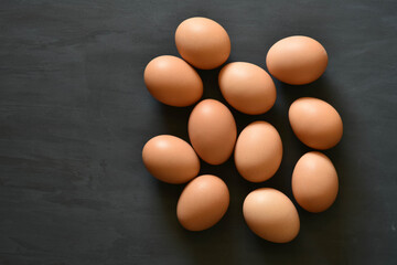 Eggs arranged in a black wooden background.