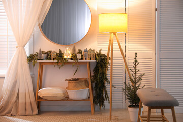 Stylish room interior with mirror and wooden console table near wall