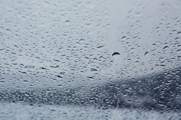 Raindrops on the transparent window pane. Background of raindrops on a  glass texture. 