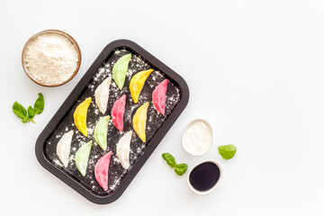 Chinese colorful raw dumplings on baking sheet, top view
