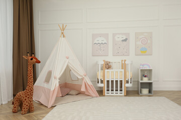 Cute baby room interior with crib and play tent