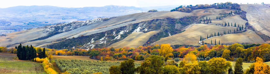 Beautiful Tuscany autumn countryside- winding road with cypresses. Italy