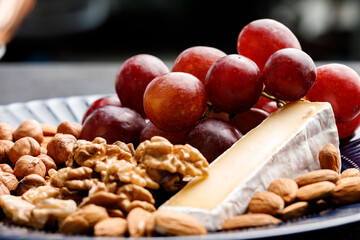 Close up of nuts and grapes on plate
