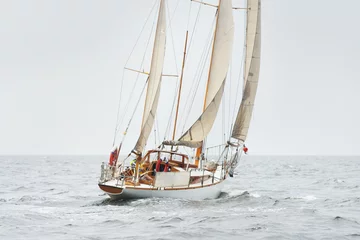 Stoff pro Meter Old expensive vintage two-masted sailboat (yawl) close-up, sailing in an open sea during the storm. Sport, cruise, tourism, recreation, transportation, nautical vessel. Panoramic view, seascape © Aastels