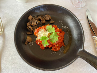 Mushrooms with tomato sauce in a saucepan