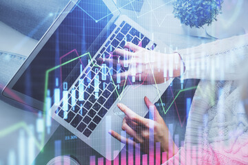 Double exposure of woman hands working on computer and forex chart hologram drawing. Top View. Financial analysis concept.