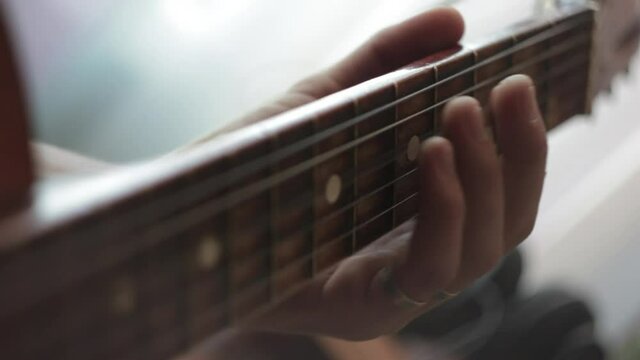 Retro guitar, man playing old acoustic guitar, close-up of playing guitar strings