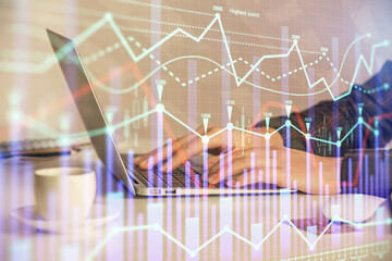 Double exposure of businesswoman hands typing on computer and forex graph hologram drawing. Financial analysis concept.