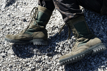 Dark green boots with laces for women and men and khaki pants