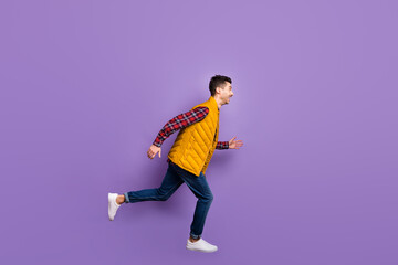 Full size profile photo of optimistic guy jump run wear shirt jeans vest isolated on violet background