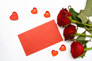 Preparation for Valentine's Day. Red envelope, and roses on a white background.