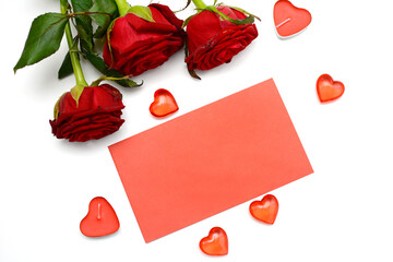 Valentine's day concept. Red roses, hearts and envelope on a white background