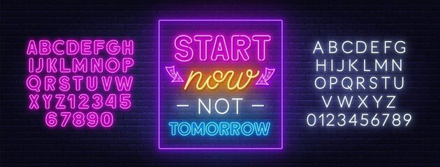 Start now not tomorrow neon quote on a brick wall. Inspirational glowing lettering. Neon pink and white alphabet on brick wall background.