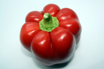 The fruit of a red sweet pepper on a white background.