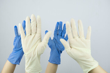 Obraz premium hands in rubber medical gloves raised up close up