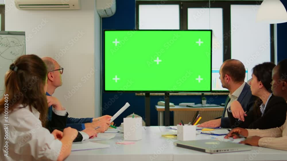 Poster tv green screen mockup ready for presentation placed in front of desk while business people working 