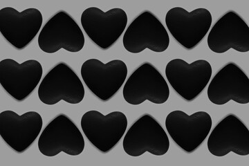 Black and white pattern of hearts on grey background.