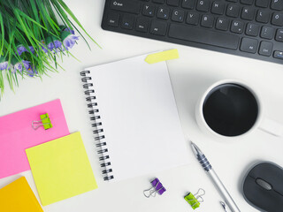 flat lay office workspace desk with coffee,blank notebook, electronic devices and computer. organizer mockup concept for blog or header image with space for text or copy space