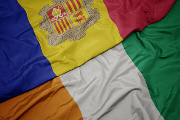 waving colorful flag of cote divoire and national flag of andorra.