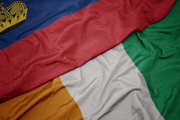 waving colorful flag of cote divoire and national flag of liechtenstein.