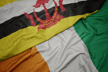 waving colorful flag of cote divoire and national flag of brunei.