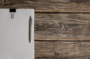 Blank notepad with pen on wooden table, business idea